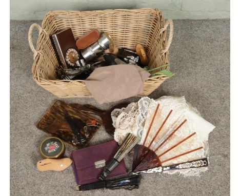 A large basket containing various ladies dress items and accessories including dressing table items, faux tortoiseshell vanit