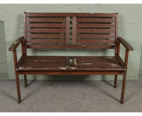 A two seat wooden garden bench.  Would benefit from re-painting.