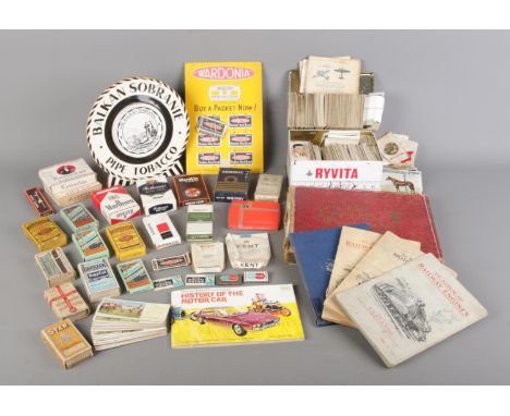 A vintage tobacco collection, comprising various vintage cigarette boxes and tobacco displays, along with a substantial quant