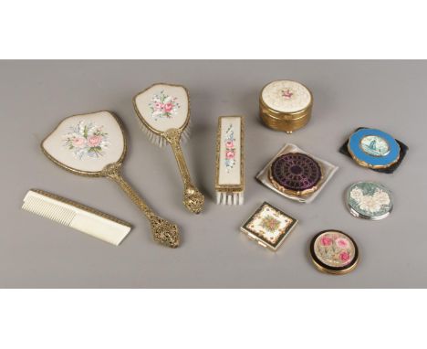 A collection of dressing table items, including vintage Delina brushes featuring petit point embroidery, Stratton powder comp