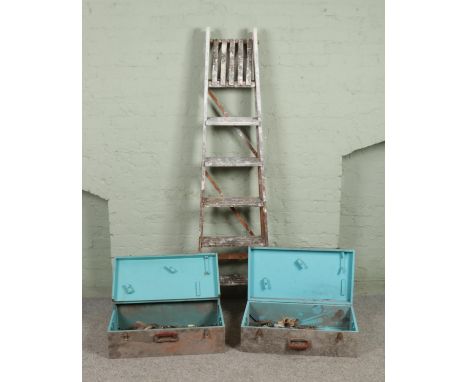 A painted set of wooden stepladders, together with two hinged chests containing a small selection of vintage tools.