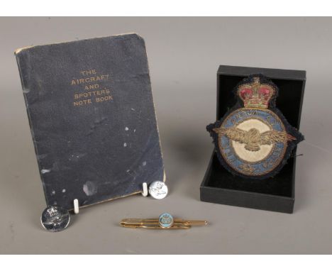 A collection of aviation items, mainly RAF. To include blazer badge, tie slide, buttons and fourth edition of 'The Aircraft a