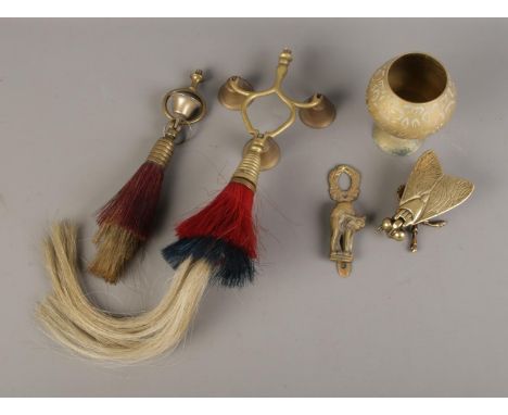 A small collection of brassware to include single and three bell horse hair terrets with plumes, fly trinket box, cup and sma
