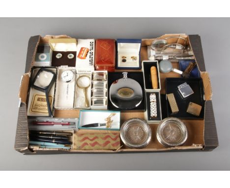 A mixed tray of collectables including a set of cut glass and white metal coasters, hip flask, lighters, magnifying glasses, 