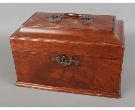 A Victorian mahogany tea caddy featuring brass handle and escutcheon.