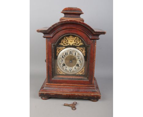 A Junghan's mantle clock featuring gilt decorated cherub to face and Arabic numeral dial.  Key present but missing pendulum.