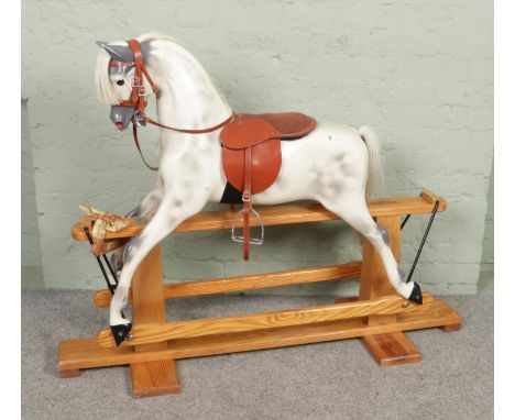 A large painted fibreglass rocking horse by Haddon Rockers. With horse hair mane and tail, leather bridle and saddle. Mounted