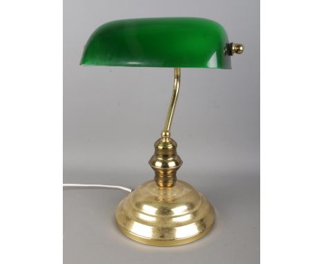 A bankers style desk lamp featuring adjustable green glass shade. Height 38cm.  Pitting to base. Working order. Some light sc