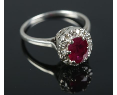 A Ruby and Diamond halo dress ring on unmarked white metal. Size Q 1/2. 3.7g.