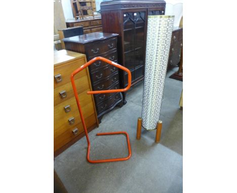 A teak rocket lamp and a metal valet stand 