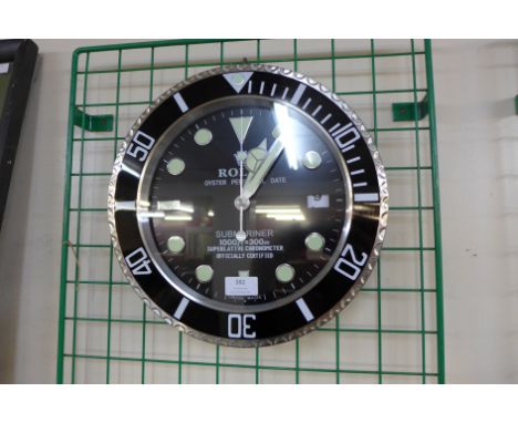 A Rolex style dealer's circular wall clock 