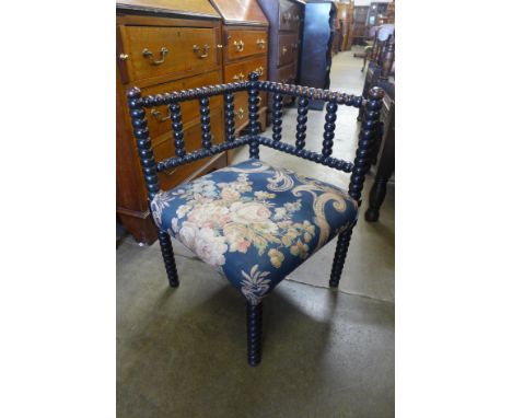An Arts and Crafts Liberty &amp; Co. style ebonised bobbin turned corner chair 