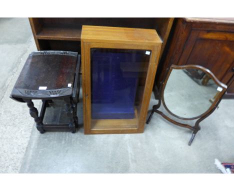 A Victorian mahogany shield shape toilet mirror, a carved oak gateleg occasional table and a display case 