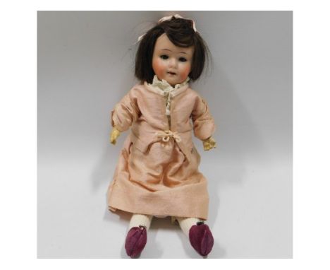 An Goebel porcelain headed doll, losses to fingers, 11in tall