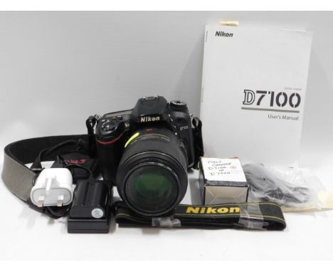 A Nikon D7100 digital SLR camera with 105mm macro lens &amp; manuals/accessories