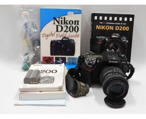 A Nikon D200 digital SLR camera with 55-200mm Sigma lens &amp; manuals/accessories