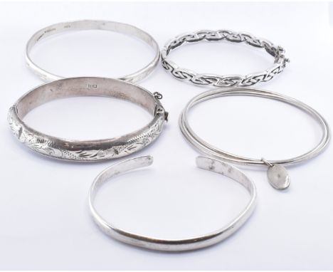 A collection of silver bangle bracelets to include a hallmarked hinged bangle bracelet (hallmarked Birmingham 1971), a celtic