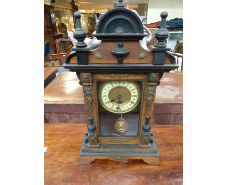 A 20th century mantel clock, the enamel chapter ring with Roman numerals, the cast metal mounted and part ebonised case with 
