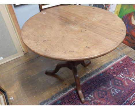A George III mahogany tripod table, the circular top above a turned support, the cabriole legs ending in pad feet, D. 