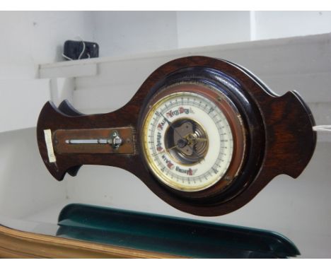 An early 20th century aneroid barometer, incorporating a thermometer, H. 35cm. 