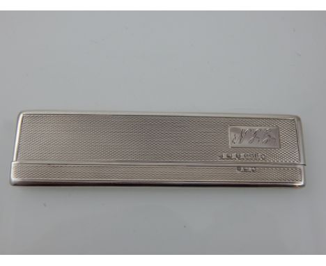 An Art Deco silver pocket comb, Birmingham 1937, the rectangular engine turned case engraved with initials, 0.8ozt.