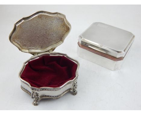 A George V silver cigarette box, Zimmerman Birmingham 1936, of canted square form with engine turned cover together with a pl