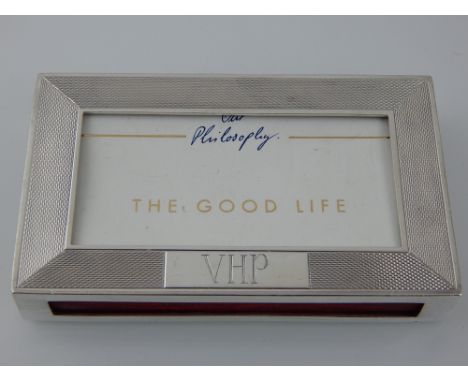 A large silver matchbox holder, London 1982 - Dunhill, of rectangular form with engine turning and a cartouche engraved VHP, 