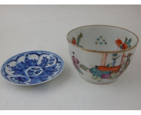 A Chinese Kangxi blue and white saucer plate, decorated with various panels of figures and blossoming flowers, bears mark to 
