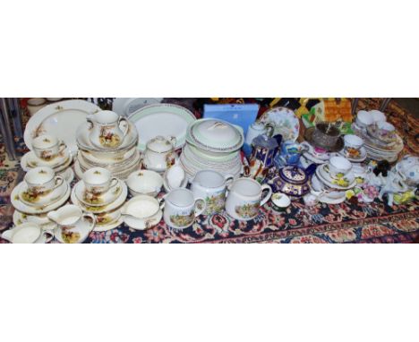 An Alfred Meakin dinner and tea setting decorated with fox hunting and fishing scenes comprising of teapot, dinner plates, cu