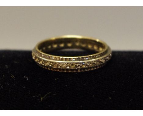 A gold coloured metal eternity ring 