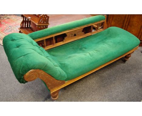 A Victorian chaise button upholstered scrolled arm, padded top rail, spindle back, turned feet, castors
