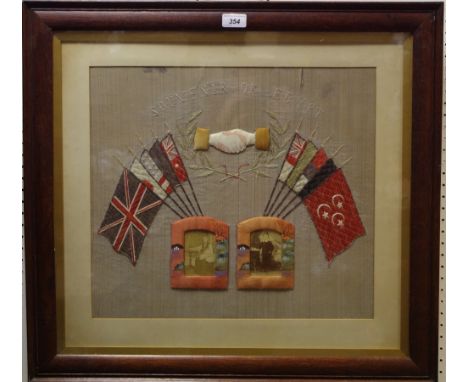 Militaria - a WWI tapestry entitled 'Souvenir of Eygpt' above shaking hands, flags of of freedom and two photographs, oak fra