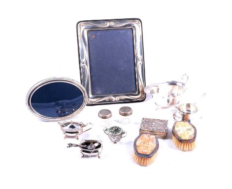 Assorted silver, including two silver mounted photograph frames, silver sauce boat, tea strainer, silver mounted jars, condim