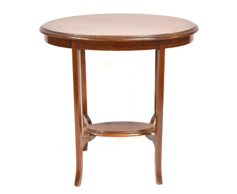 Edwardian mahogany side table, oval form, inlaid outline, the legs joined by a shelf, 76cm long, 48cm wide, 77cm high.Conditi