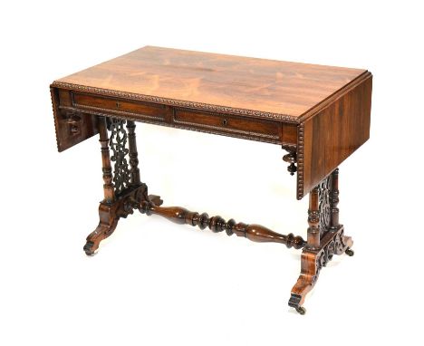 Victorian rosewood sofa table, rectangular top with two drop leaves, beaded edge, turned columns with fretted panels, turned 