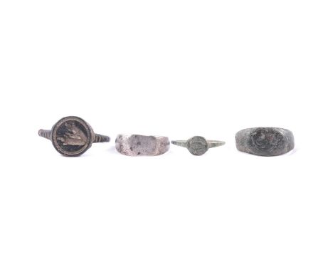Three Roman rings and another ring, a Roman ring, bull's head intaglio with circular border to head, shank misshapen; another