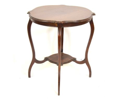 Mahogany window table, shaped outline, curved supports joined by a small shelf, 66cm diameter, 73cm high.
