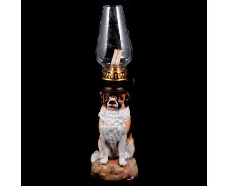 A German novelty ceramic oil lamp in the form of a St Bernard, stamped EBS 5375 for Ernst Bohne &amp; Söhne, with clear glass
