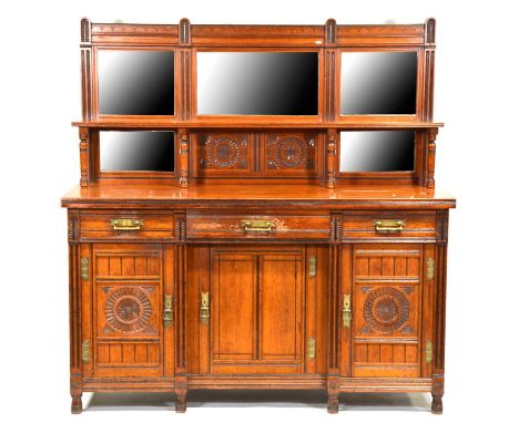 Late Victorian walnut sideboard, raised back with bevelled mirrors and a shelf, the base with three drawers above carved cupb
