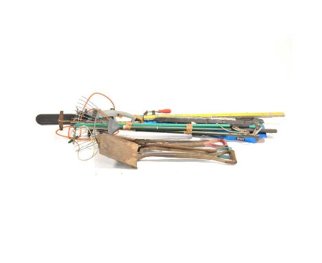 Quantity of garden tools, including a electric chainsaw, spades, forks, rakes and hoes.