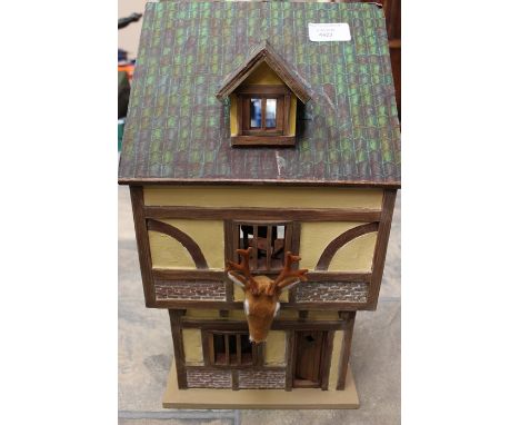 A German style dolls house in the form of a hunting lodge, with contents to the interior