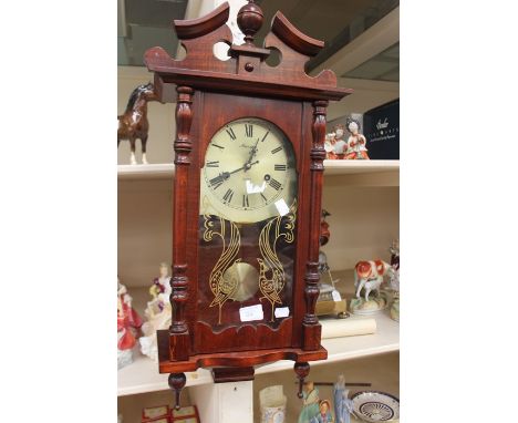 A mahogany Maxime 31 day wall clock.