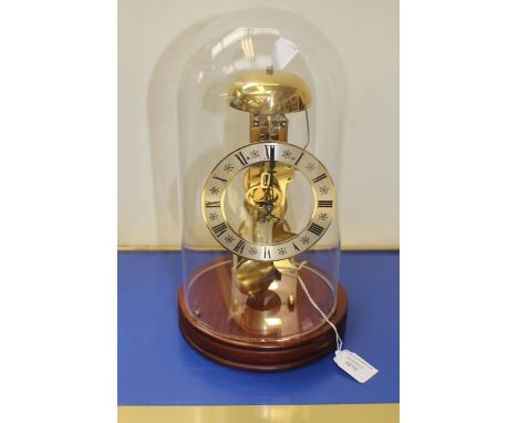 A 20th Century West German skeleton clock, circa 1970's with glass globe, teak plinth