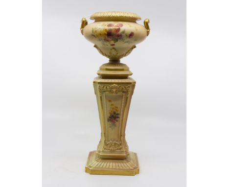 A Royal Worcester blush vase in the form of an urn on pedestal stand, floral decoration heightened with gilt, with registered