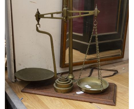 Brass weighing scales on wooden plinth and brass weights&nbsp;