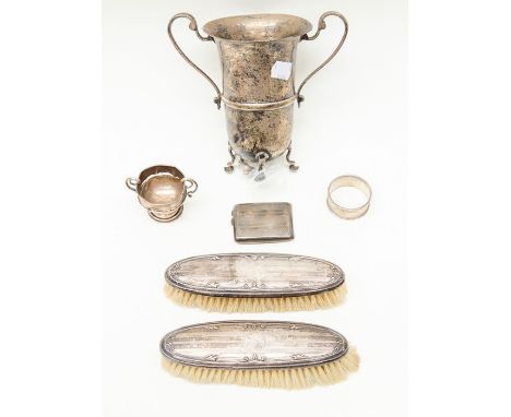 Assorted silver pieces including a pair of Chester silver brushes, London silver two handled cup/vase on legs, Birmingham sil