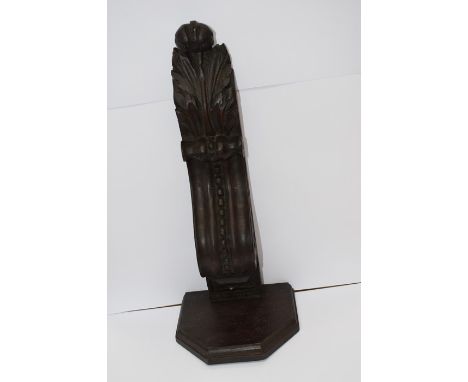 An ornate carved wooden wall bracket
