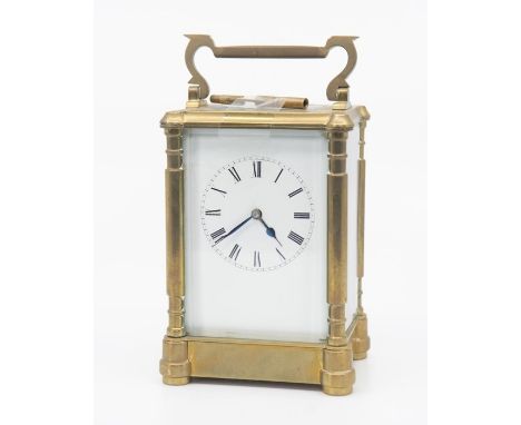 A French carriage clock, probably 19th century, with&nbsp;bevelled glass to front, sides, back and top, the white&nbsp;enamel