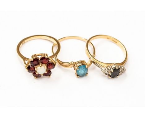 Three 9ct gold dress rings to include a sapphire ring size M1/2 along with a garnet and opal version, sizde K1/2, and a blue 