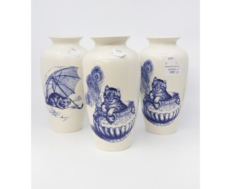Three Poole Pottery blue and white cat design vases, two patterns, 21 cms in height approx